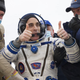 NASA astronaut Christopher Cassidy (C) thumbs up as he leaves the Soyuz MS-16 reentry capsule